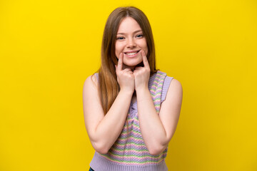 Young caucasian woman isolated on yellow background smiling with a happy and pleasant expression