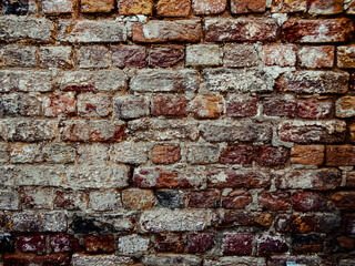 old crack brick wall texture. vintage dramatic background of rough broken blocks