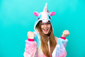 Young caucasian girl with unicorn pajamas holding pillow  smiling with a sweet expression