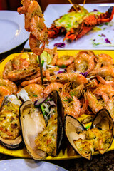 Tasty prawns and mussels in plate in restaurant