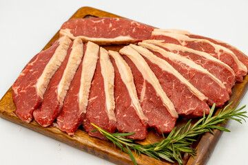 Beef fillet isolated on a white background. Raw beef tenderloin on wooden serving board. close up