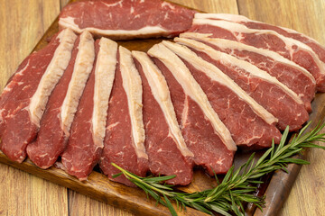 Beef fillet on a wooden background. Raw beef tenderloin on wooden serving board. close up