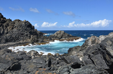 Fototapeta na wymiar Beautiful Aruba Landscape of Lava Rocks and Ocean