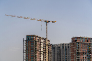 Fototapeta na wymiar Tower crane on the construction of skyscrapers