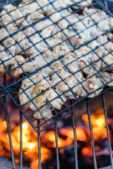 Grilled Chicken on Grid over Barbeque Fire Flames