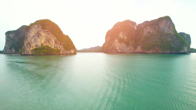 Aerial sunset above mountain silhouette. Beautiful views of the Andaman Sea. &ldquo;Underwater Wedding Beach&rdquo; Trang, Thailand. 4k drone footage
