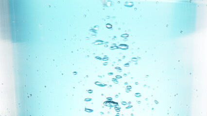 Texture of bubbling water in glass, detail shot.
