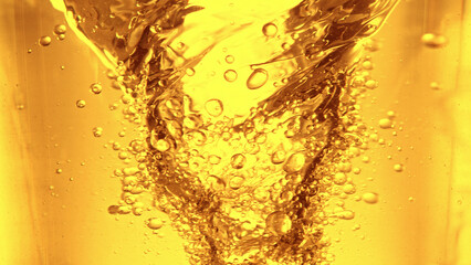 Liquid golden oil texture, abstract background.