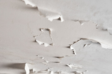 Peeling paint in plaster ceiling of bathroom and toilet. Moisture and humidity in room