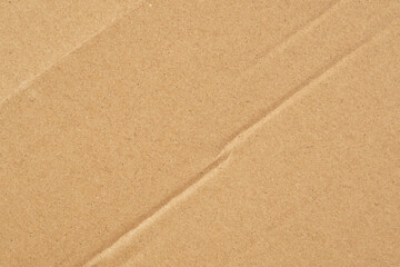 Wrapping paper crease. Wrinkled brown texture. Crumpled background