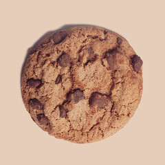  isolated  chocolate chip cookie on brown background
