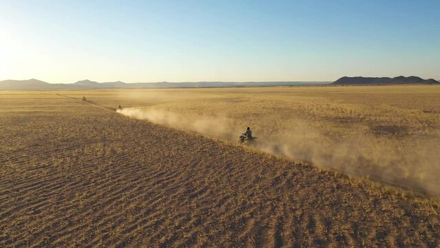 Aerial view of people riding quads off road in Namib desert, Namibia.