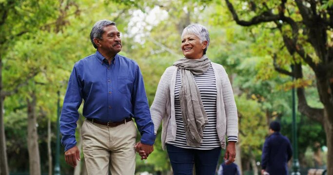 We still fall more and more in love each day. 4k video footage of a mature couple out for a walk at the park.