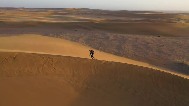 Aerial view of people walking on a sand dune crest in Namib Desert, Namibia.