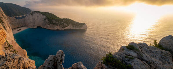 Navagio beach with wreck and flowers at sunset in Zante, Greece. Zakynthos island. Ionian sea, with...