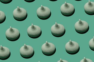 delicious sweet meringues on green background pattern