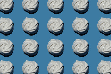 a lot of sweet marshmallows on a blue background pattern