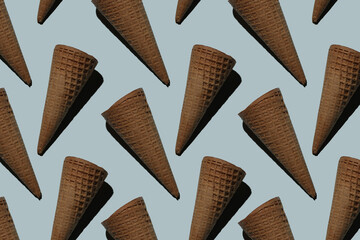many empty ice cream cones on a blue background