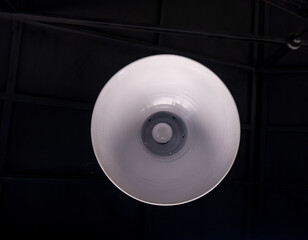 Abstract hanging lamps with bottom view ,hanging lights bulb on ceiling with black background. Bottom view of round yellow lamps. Light bulb in a round lampshade.