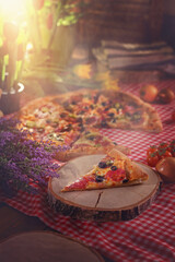 pizza in a pizzeria with salami and vegetables