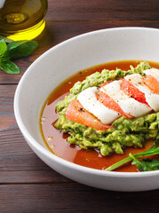 Healthy snack with avocado, squid, grapefruit and basil. Close up. Mashed avocado puree, sauce, seafood. Copy space. The concept of healthy eating. Healthy food. Top view. Wooden background. Diet food