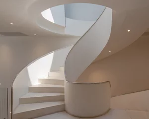 Fotobehang Trappen Modern spiral staircase architecture building is a beautiful design and makes the most of limited spaces for an office building with light and shadow and color shade.  © pomphotothailand