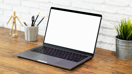 mock up empty screen computer on wood desk, Laptop computer with blank white screen on table in office.with clipping path
