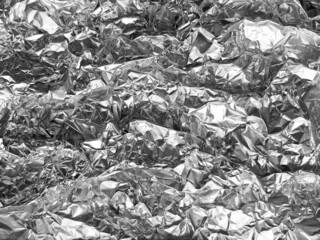 Silver foil  with shiny crumpled surface texture background
