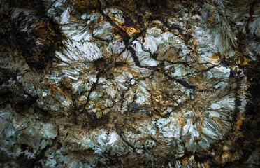 Dark background of natural stone. Detail of a Hedenbergite mineral wall found in Elba island, Italy.