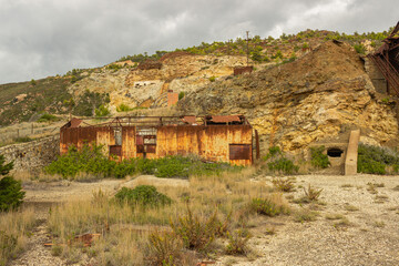 Abandoned industrial landscape. Rusty sheet metal shelter in the iron quarry. Mining park of the island of Elba.