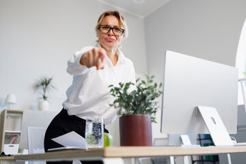 Angry female boss in office pointing finger
