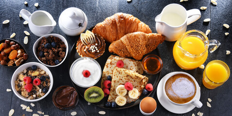 Breakfast served with coffee, juice, pancakes and croissants