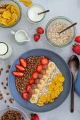 healthy breakfast bowl for children with oats, fruits and chocolate flakes