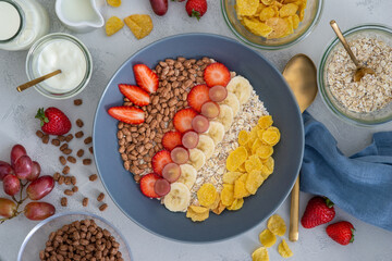 healthy breakfast bowl for children with oats, fruits and chocolate flakes