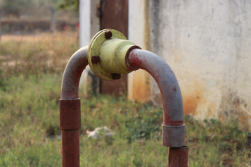 Old borewell motor and pump system with galvanized piping for water outlet with a nonreturn valve designed for irrigation purposes
