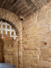 Medieval gate with a wooden latticed grille in the city wall of Alcudia, Majorca island, Spain