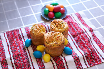 Easter cake and eggs on traditional ukrainian embroidered towel
