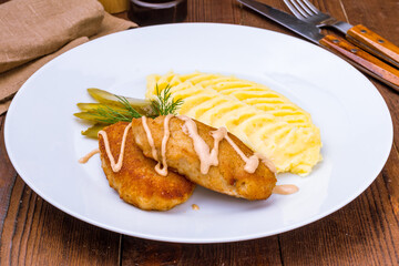Chicken cutlets with mashed potatoes on a white plate
