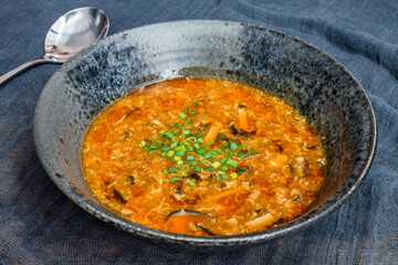 sour and spicy chinese soup on black bowl