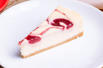 strawberry cheesecake on a white plate macro close up