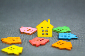 a model of a colored wooden house with the concept of a housing crisis