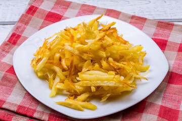 french fries on a white plate side view