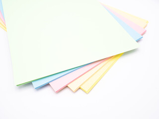 Abstract background with rainbow colored paper, white background, pastel shades