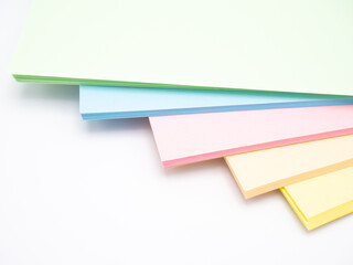 Abstract background with rainbow colored paper, white background, pastel shades