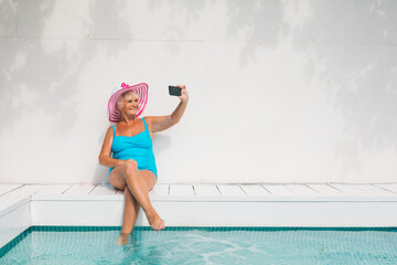 Happy senior woman at the swimming pool
