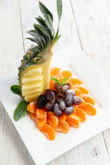 Assorted fruits in a bowl. On a light background.
