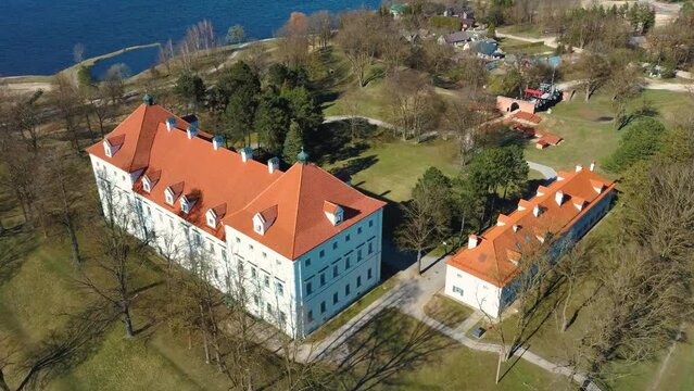 Aerial Shot of Birzai Castle, Fortress Birzai - a Castle in Birzai, on the Southern Coast of the Lake &Scaron;irvėna in Lithuania, Sunny Spring Day. Historic Beautiful Church and Birzai City Panorama 4K UHD 