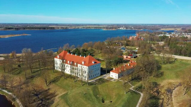 Aerial Shot of Birzai Castle, Fortress Birzai - a Castle in Birzai, on the Southern Coast of the Lake &Scaron;irvėna in Lithuania, Sunny Spring Day. Historic Beautiful Church and Birzai City Panorama 4K UHD 