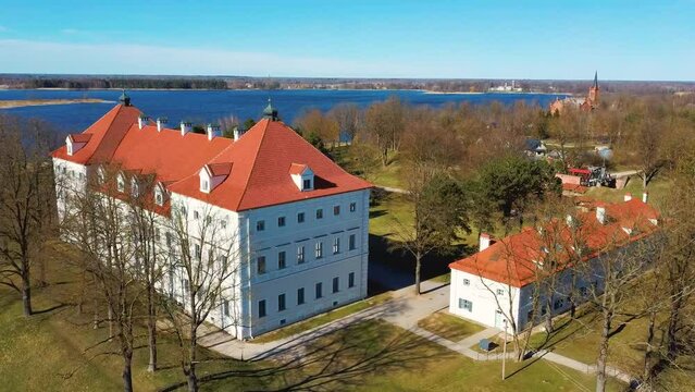 Aerial Shot of Birzai Castle, Fortress Birzai - a Castle in Birzai, on the Southern Coast of the Lake &Scaron;irvėna in Lithuania, Sunny Spring Day. Historic Beautiful Church and Birzai City Panorama 4K UHD 