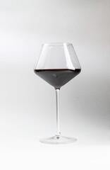 Glass with red wine. On a light background.